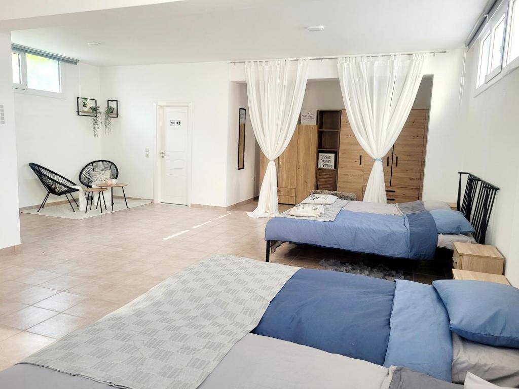 a bedroom with two beds and a living room at Villa Maritsá in Pastida