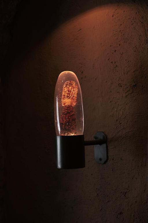 a light hanging on a wall in the dark at Antigua Casona San Blas in Cusco