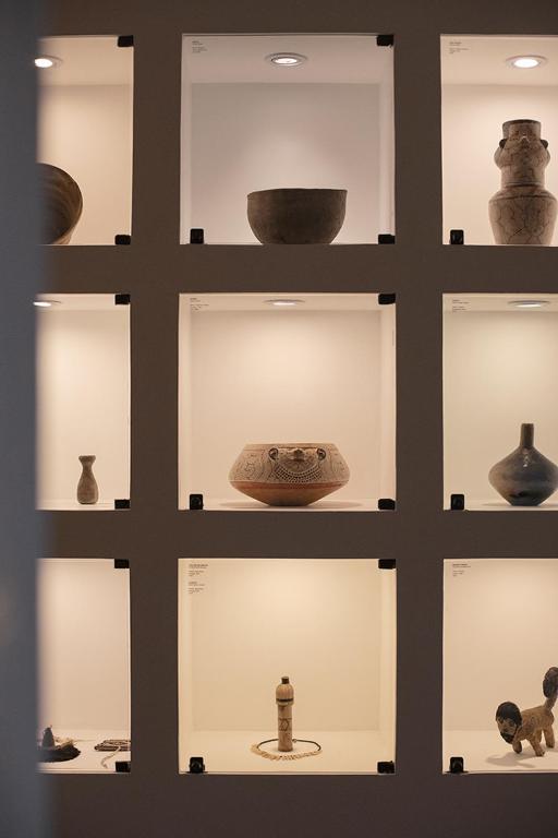 a display case with pots and vases on display at Antigua Casona San Blas in Cusco