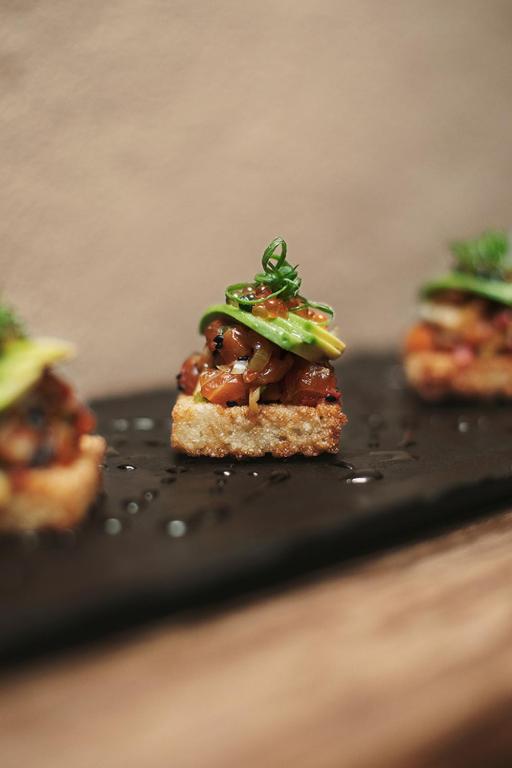 a close up of a piece of food on a black plate at Antigua Casona San Blas in Cusco