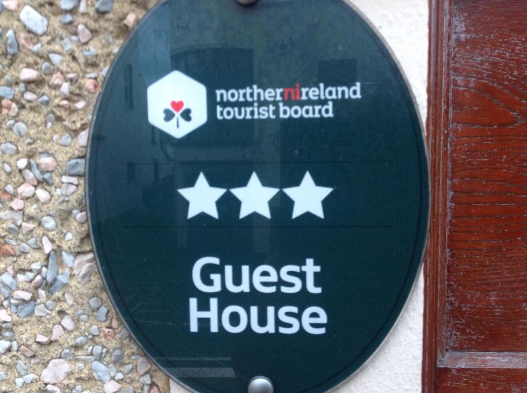 a guest house sign on the side of a building at Beulah Guest House in Portrush