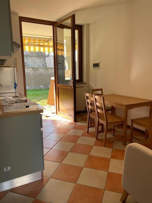 a kitchen with a table and a table and chairs at La Sosta Vercellese in Borgo Vercelli