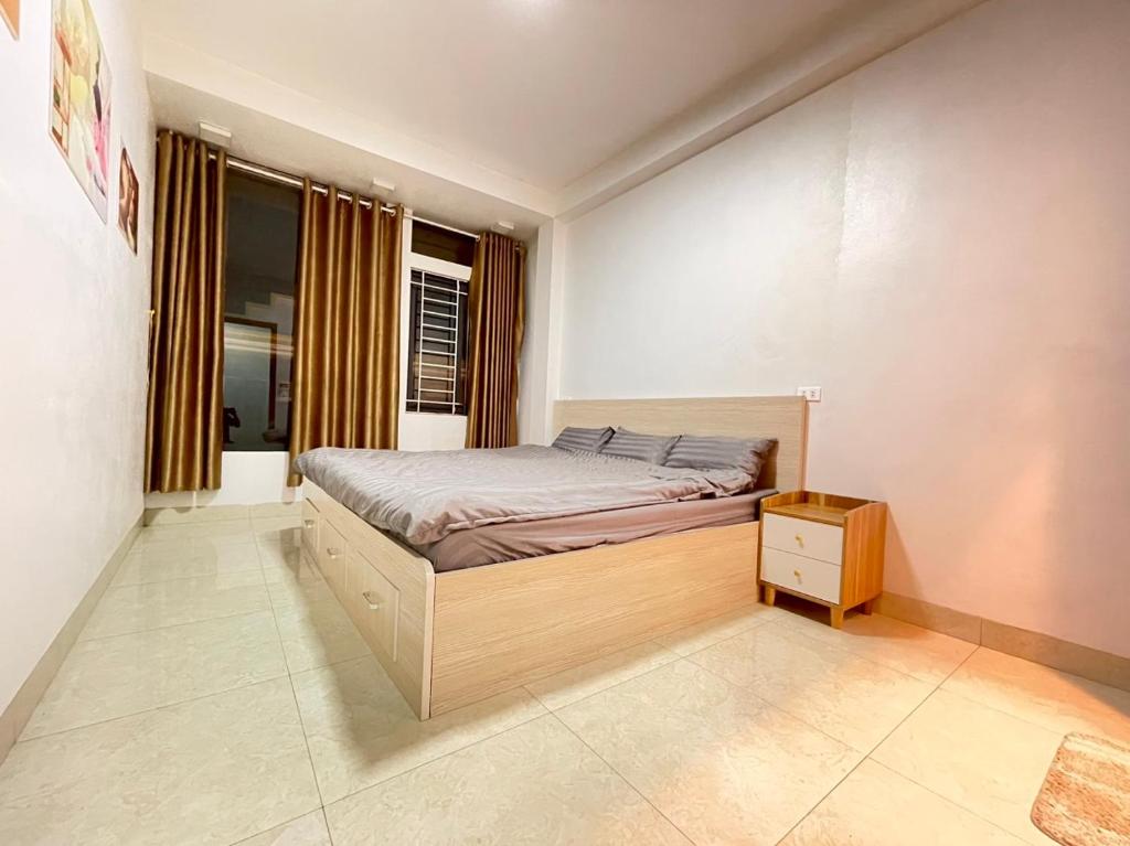 a small bedroom with a bed and a window at Nhat Sapa Hostel in Sapa