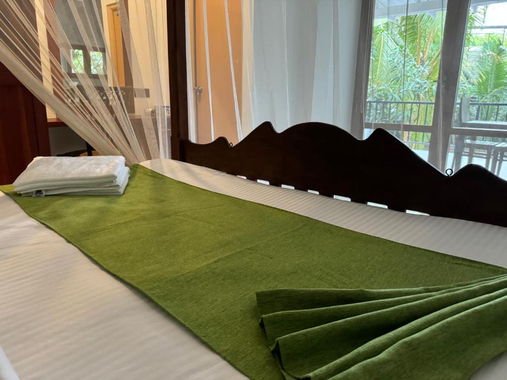 Postel nebo postele na pokoji v ubytování Brinkhouse Guesthouse , Unawatuna beach