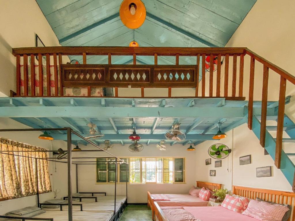 a room with a loft with a bed and a staircase at Homestay in Tay Ninh in Tây Ninh