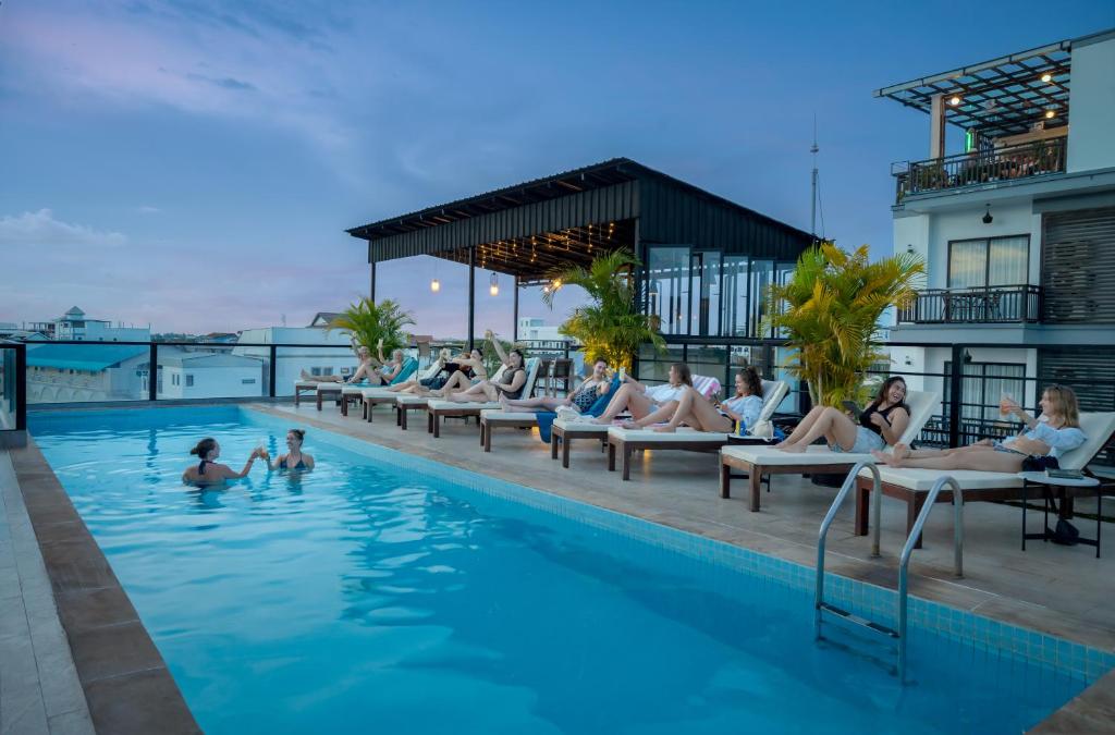 a group of people sitting in the pool at a hotel at Onederz Siem Reap in Siem Reap
