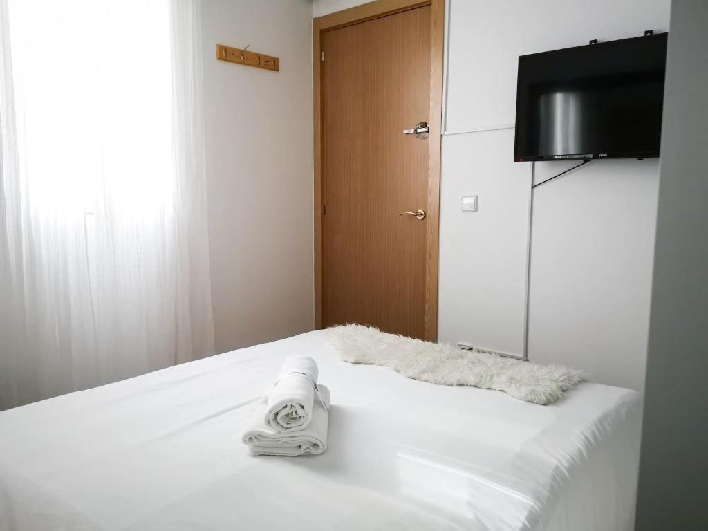 A bed or beds in a room at Apartamentos Day Madrid ILDEFONSO Centro Gran Via Sol Malasaña