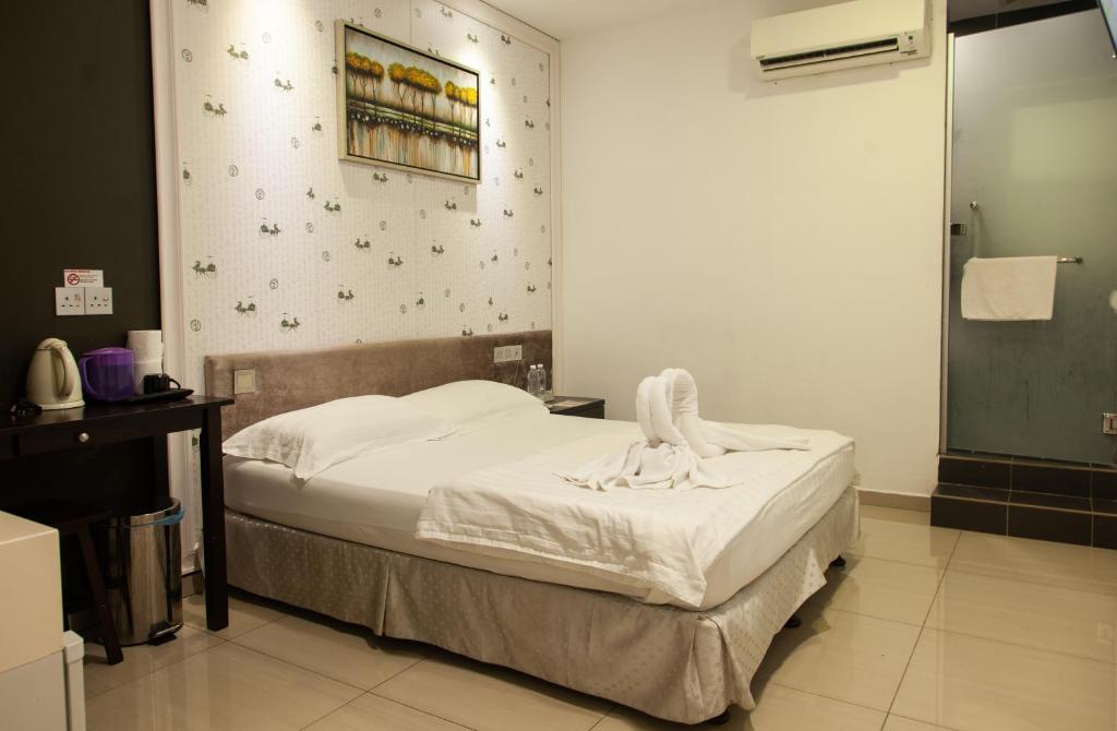 Postel nebo postele na pokoji v ubytování M Design Hotel @ Seri Kembangan