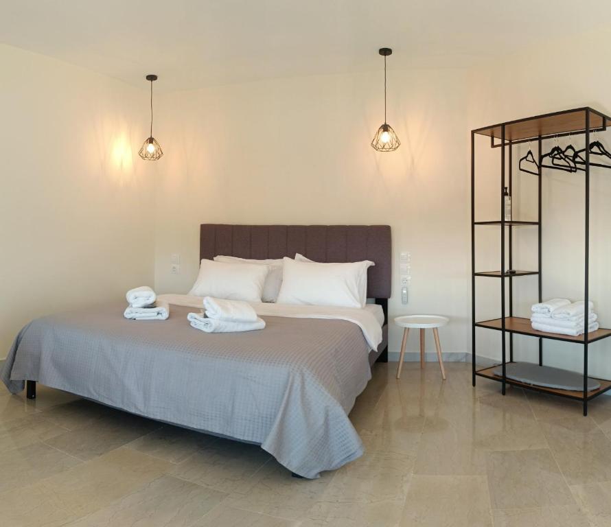 a bedroom with a bed with two towels on it at Athens Experience 1 in Athens