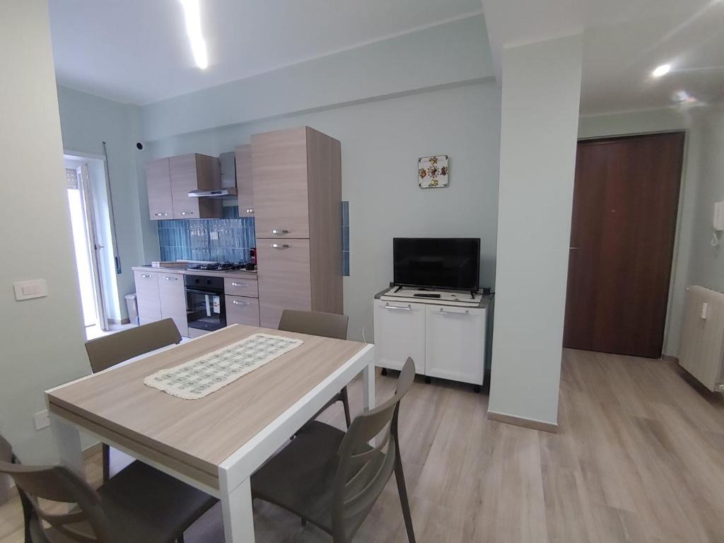 a kitchen and dining room with a table and chairs at "A casa dei Nonni" House near the metro C in Rome