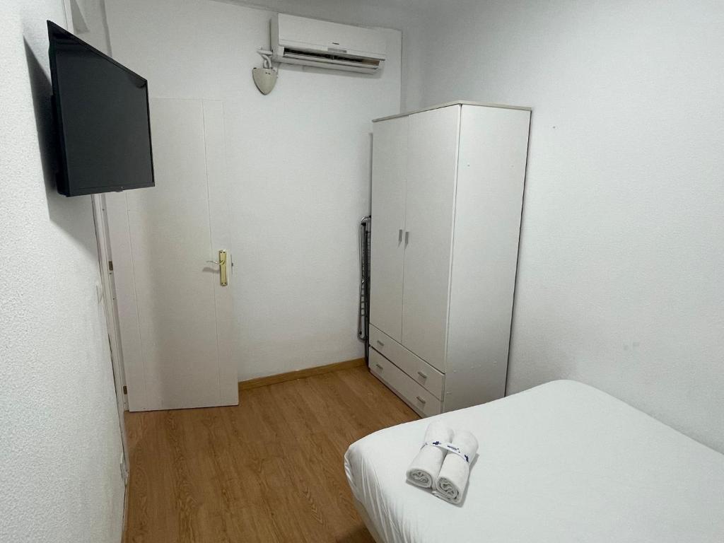 A television and/or entertainment centre at Apartamentos Day Madrid SANTO DOMINGO Centro Gran Via Sol Malasaña