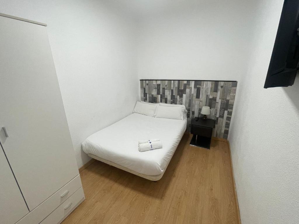 A bed or beds in a room at Apartamentos Day Madrid SANTO DOMINGO Centro Gran Via Sol Malasaña