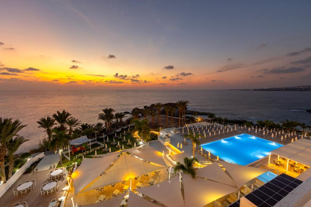 an aerial view of a resort with a swimming pool at Queens Bay Hotel in Paphos