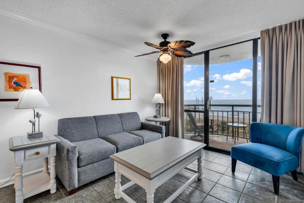 a living room with a couch and a table at Meridian Plaza 404 in Myrtle Beach