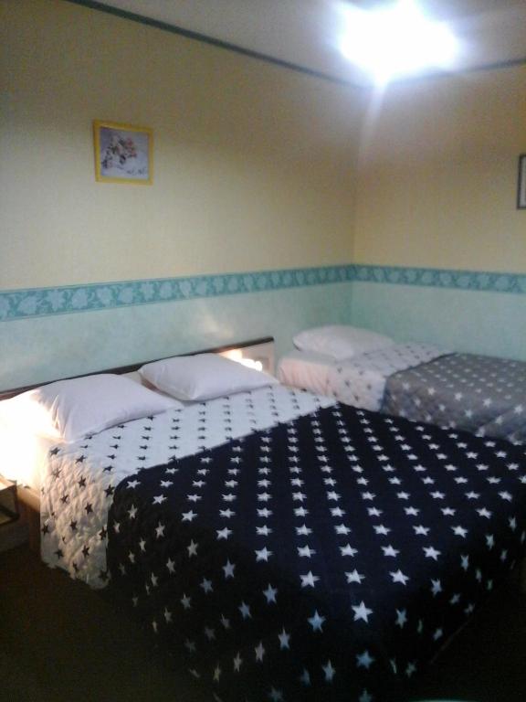 Postel nebo postele na pokoji v ubytování Hôtel l'Eden