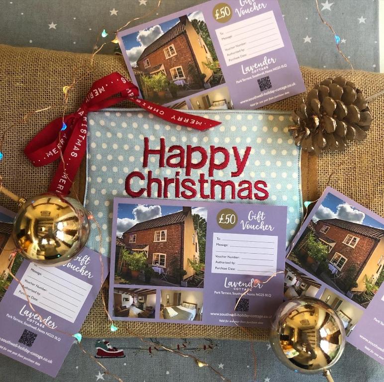a christmas gift with a merry christmas sign on it at Southwell Holiday Cottage - Lavender Cottage in Southwell