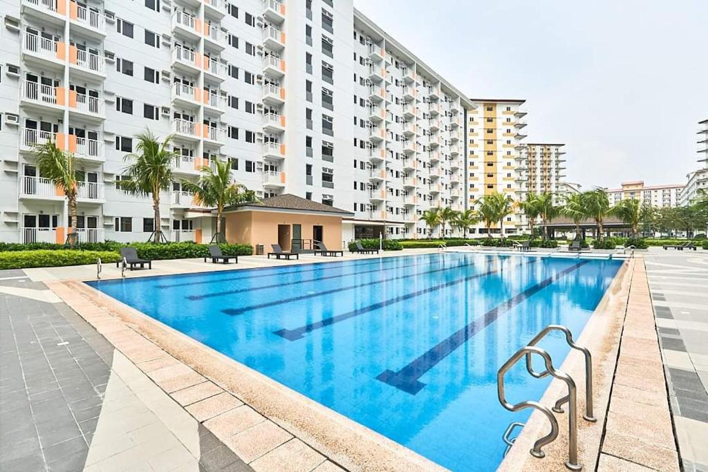 a large swimming pool in front of a building at Cozy and Aesthetic Unit near to NAIA Airport Y&N Staycation in Manila