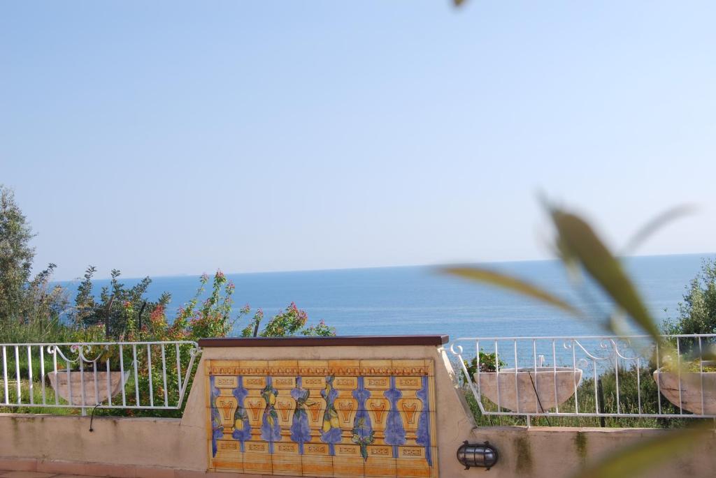 a balcony with a gate and the ocean in the background at Hotel Belvedere in Sperlonga