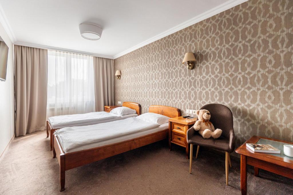 Postel nebo postele na pokoji v ubytování Hotel Podlasie