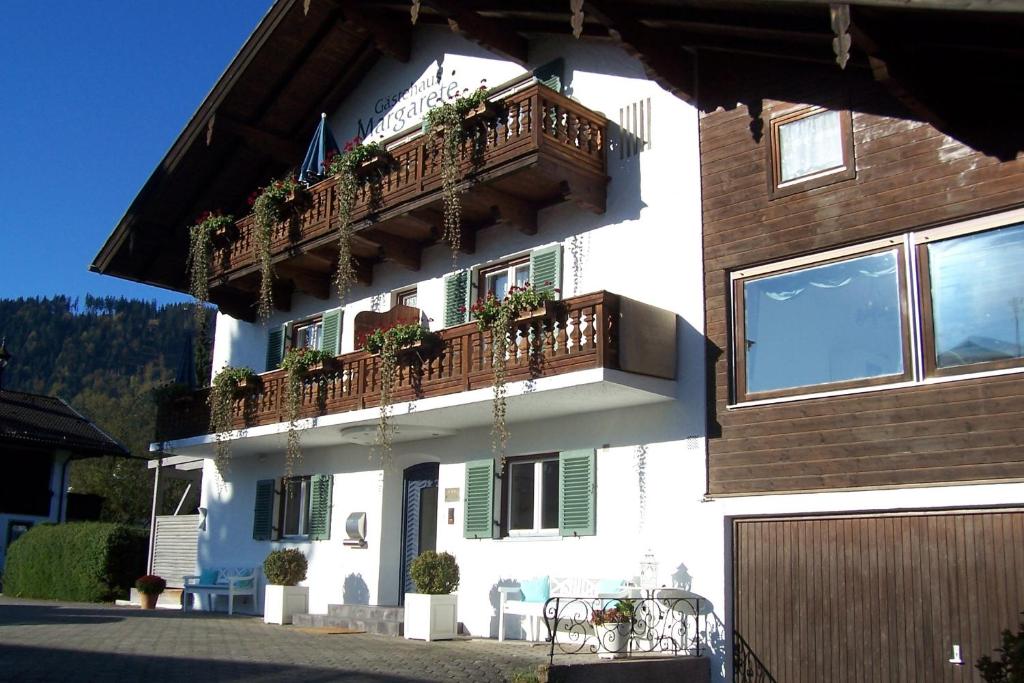 ein Gebäude mit einem Balkon mit Pflanzen in der Unterkunft Gästehaus Margarete in Bad Wiessee