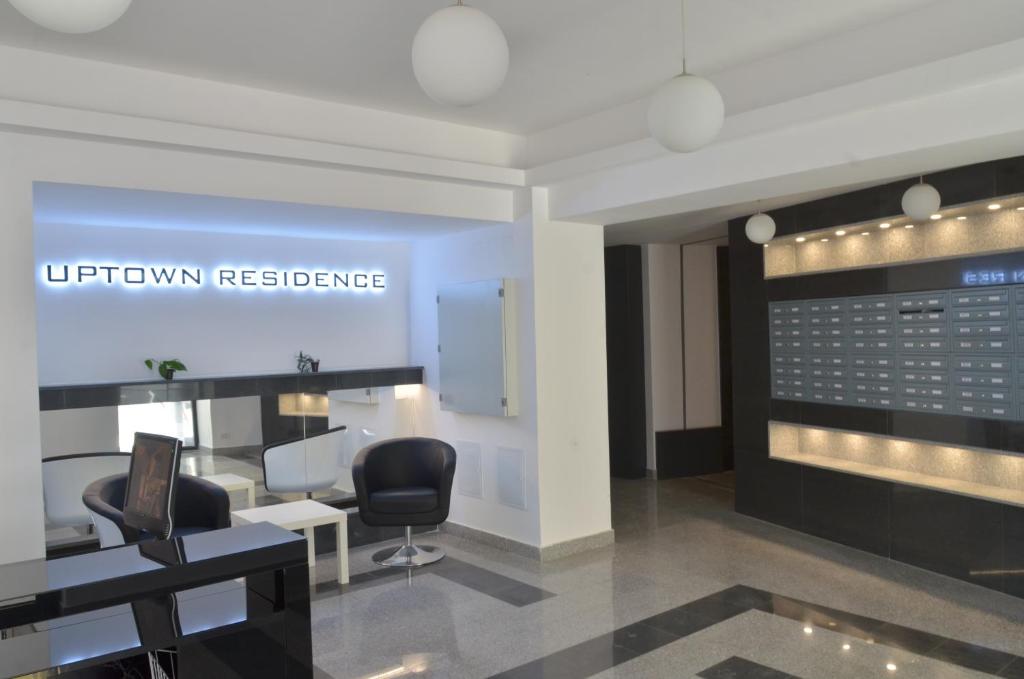 a salon with two chairs and a sign that reads uptown reference at Uptown Residence Apartments in Bucharest