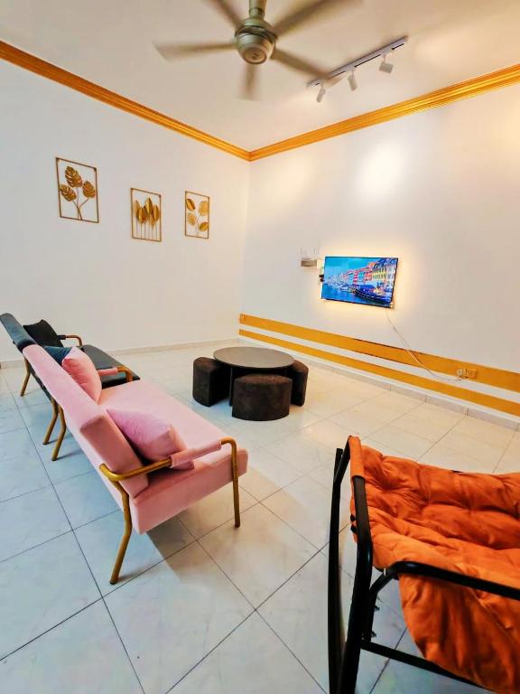 a living room with a couch and a table at GOLDEN HOUSE ,1min to aeon, 7min to zoo,8min to lake gardens in Taiping