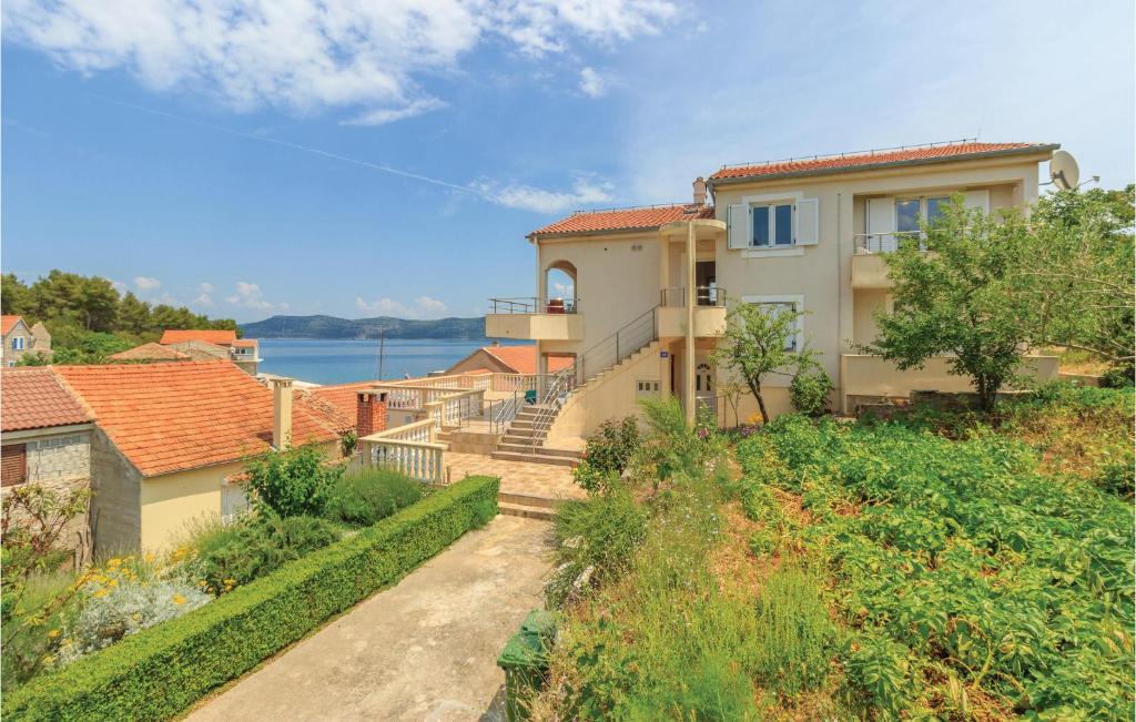 dom ze schodami prowadzącymi do niego w obiekcie Apartment Komoseva I w mieście Mali Iž