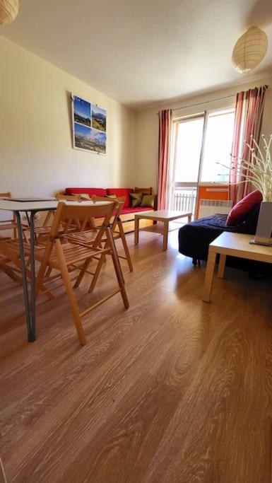 un salon avec une table et un canapé dans l'établissement Appartement d'angle , les Issarts, à Superdevoluy