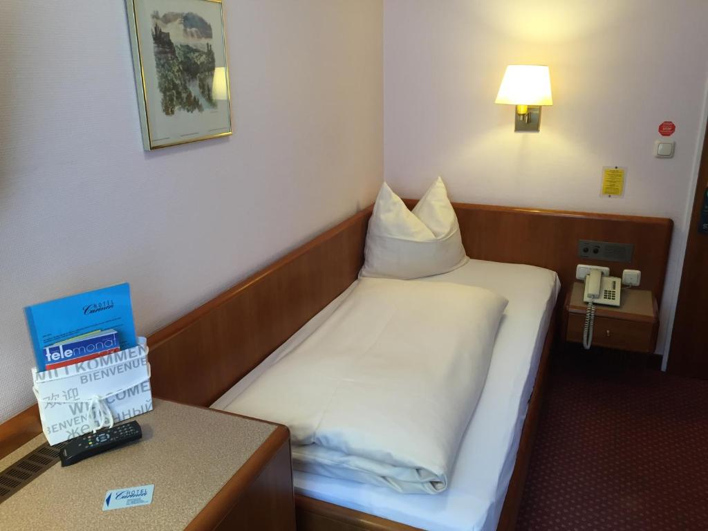 Postel nebo postele na pokoji v ubytování Hotel Carmen