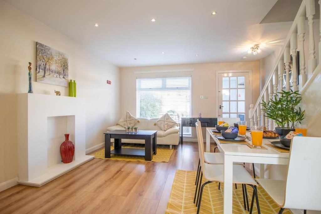 a living room with a table and a dining room at Lena House in Glasgow