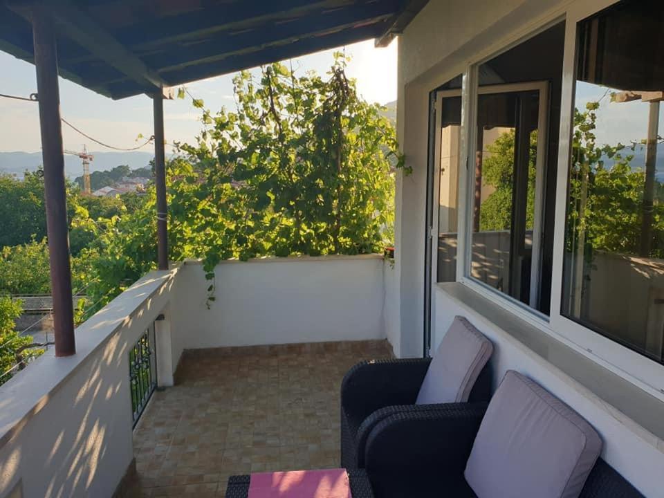 a porch with two chairs and a balcony with a view at Apartment LoLi in Orebić