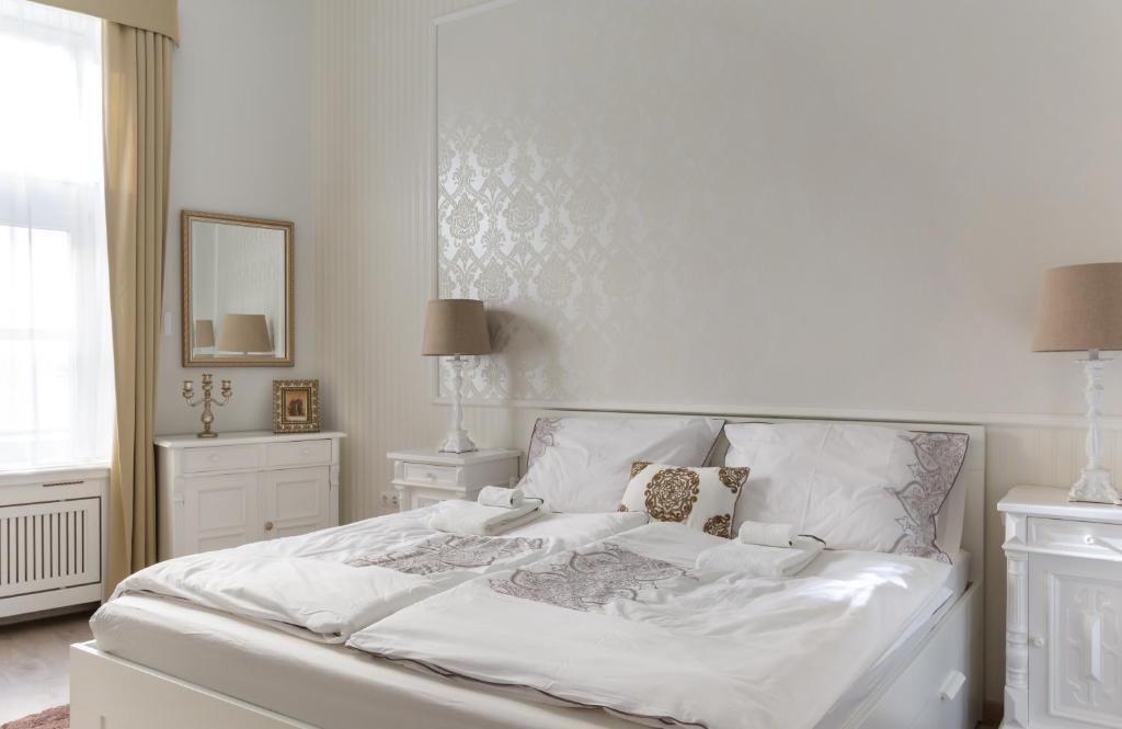 A bed or beds in a room at Chestnut & Eliza Suites - Superior Homes Downtown