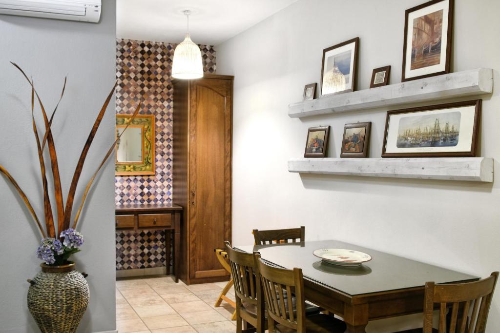 a dining room with a table and chairs at Niriides Luxury Apartments in Syvota
