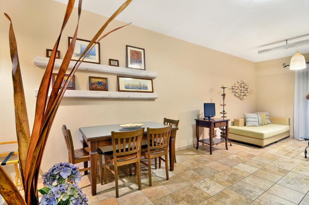 a dining room and living room with a table and chairs at Niriides Luxury Apartments in Syvota