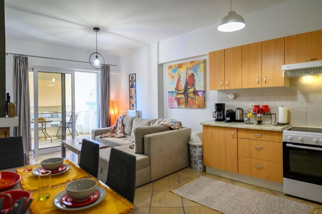a living room and kitchen with a couch and a table at Premium Athenian District Urban 1 bedroom flat C in Athens