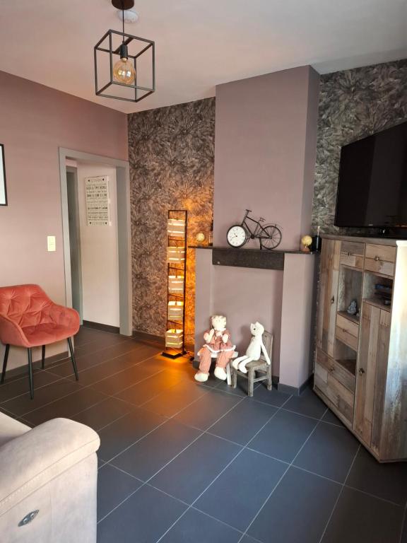 two teddy bears sitting on chairs in a living room at Maison touristique à Bouillon avec jardin in Bouillon