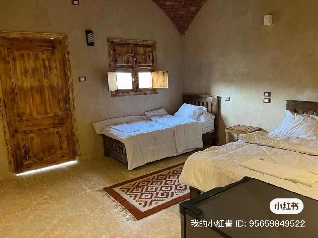 Postel nebo postele na pokoji v ubytování فندق إريغن Erighin siwa hotel
