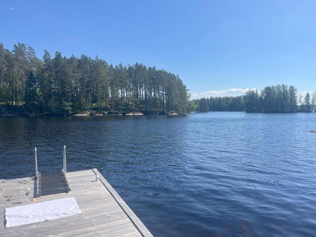 a dock on a lake with trees in the background at 5 person holiday home in KARLSKOGA in Karlskoga