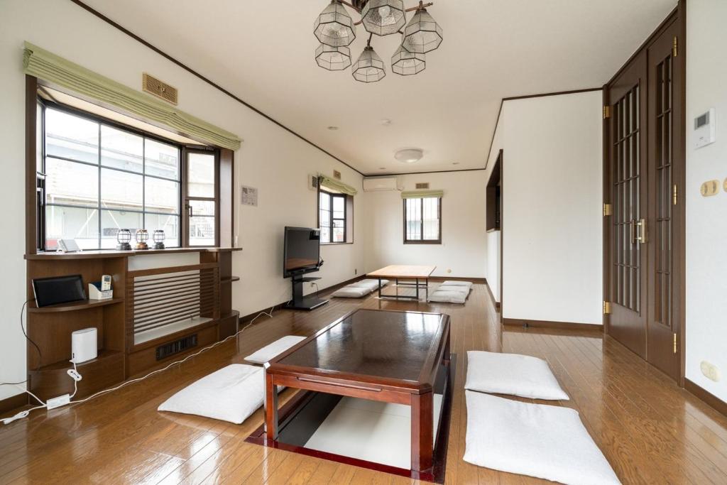 a living room with a table and a tv at Hamanoakariya Kujukuri in Katakai