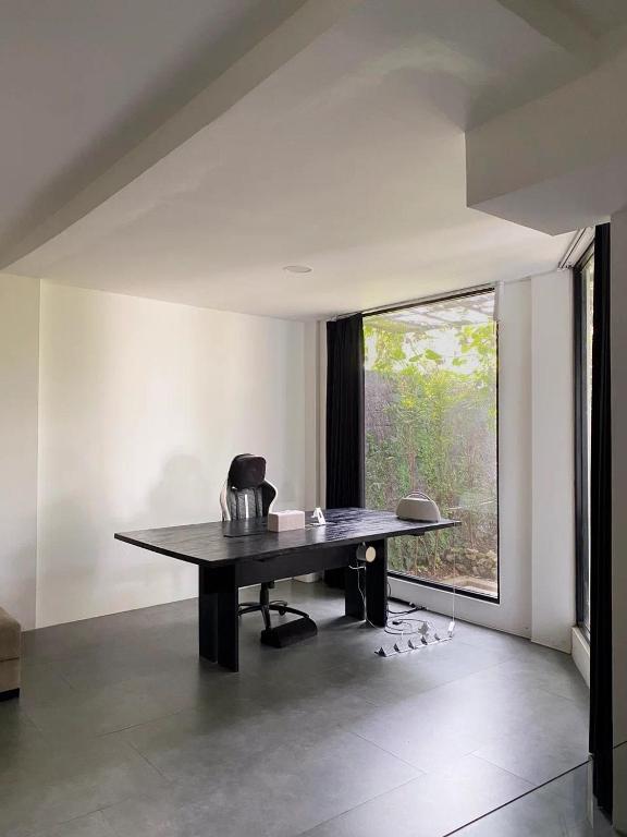 a dining table in a room with a window at Villa Valeria in Ungasan