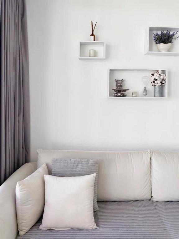 a white couch with two pillows in a living room at Villa Valeria in Ungasan