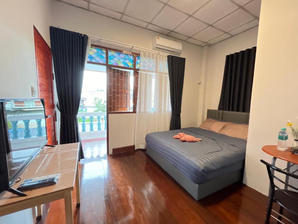 Postel nebo postele na pokoji v ubytování A Plus Hometel - บ้านเอ๋ โฮมเทล