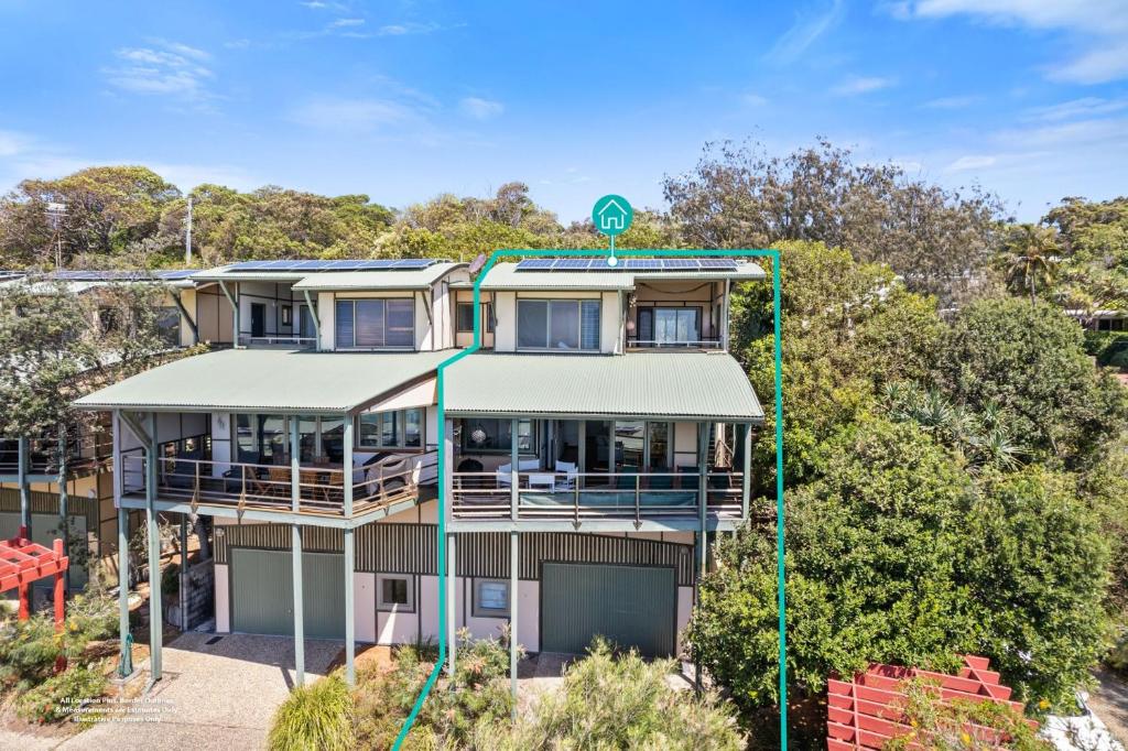 an apartment building with a green address sign on it at Claytons 7 by Discover Stradbroke in Point Lookout