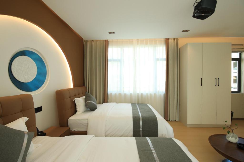 Postel nebo postele na pokoji v ubytování Dali Yufu B&B Hotel