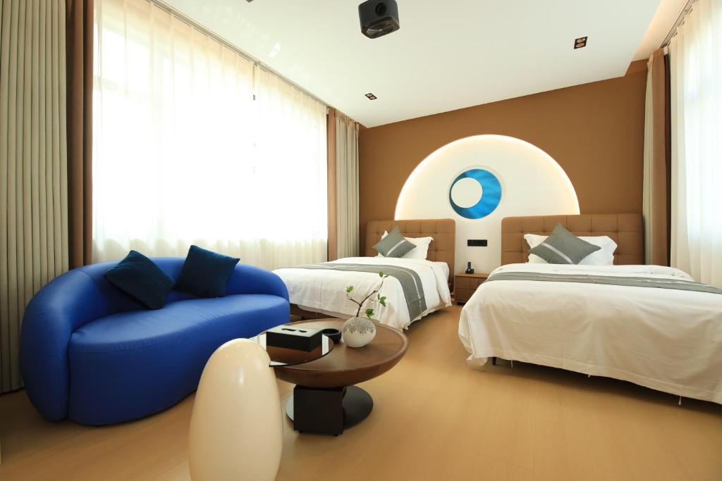 Postel nebo postele na pokoji v ubytování Dali Yufu B&B Hotel