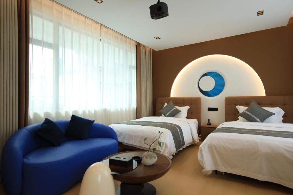 Postel nebo postele na pokoji v ubytování Dali Yufu B&B Hotel