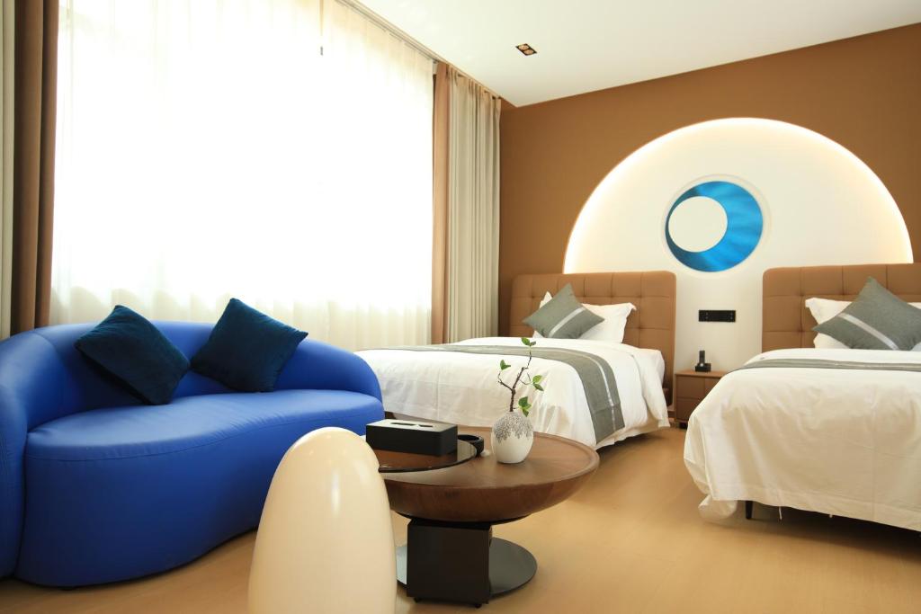 Postel nebo postele na pokoji v ubytování Dali Yufu B&B Hotel