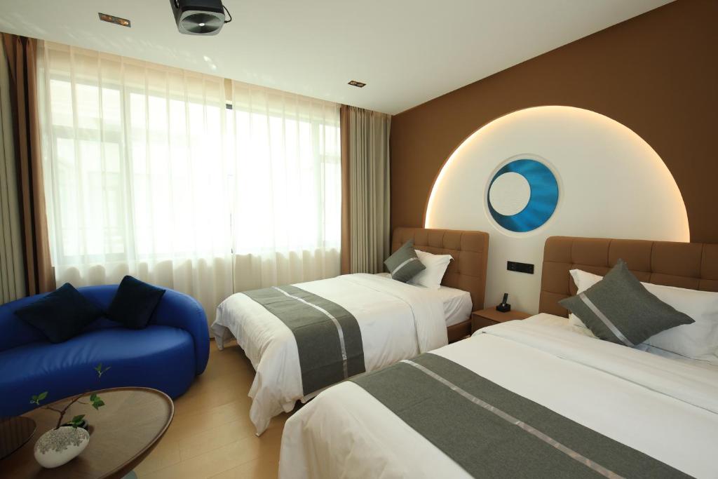 Postel nebo postele na pokoji v ubytování Dali Yufu B&B Hotel
