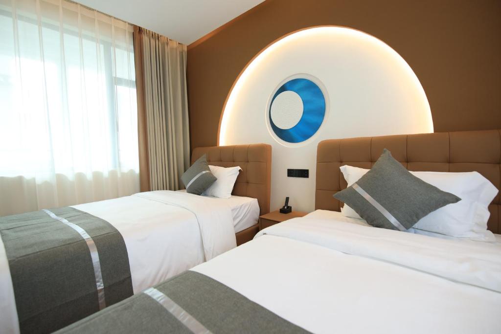Postel nebo postele na pokoji v ubytování Dali Yufu B&B Hotel