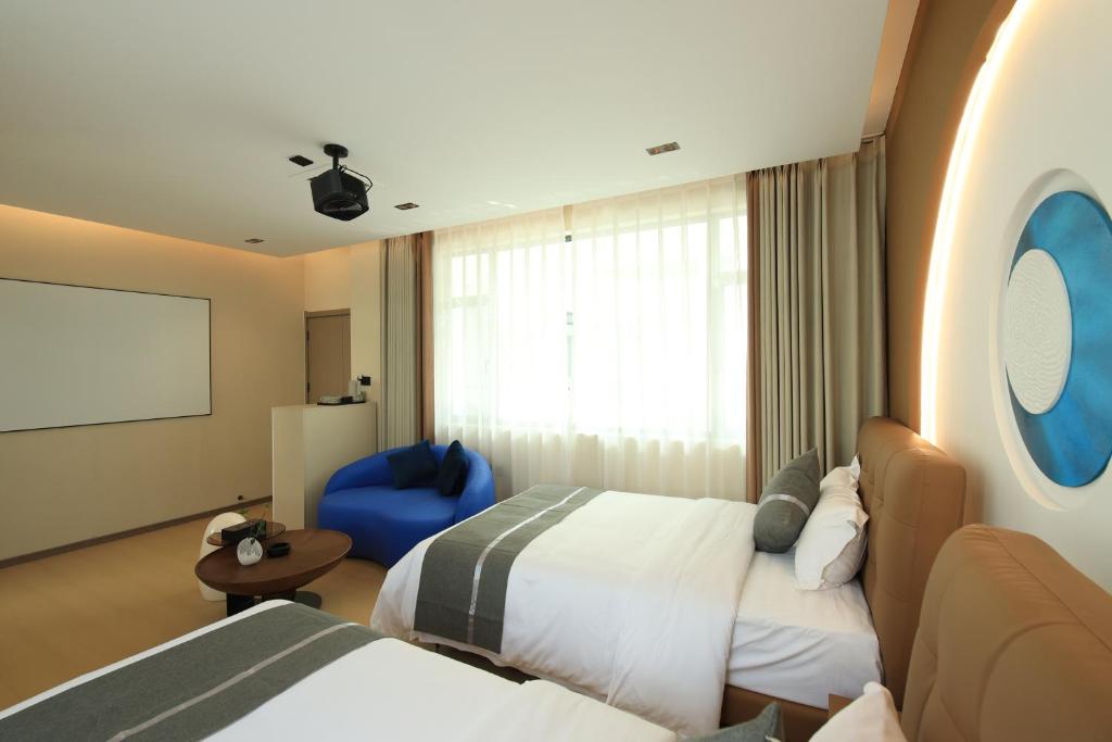 Postel nebo postele na pokoji v ubytování Dali Yufu B&B Hotel